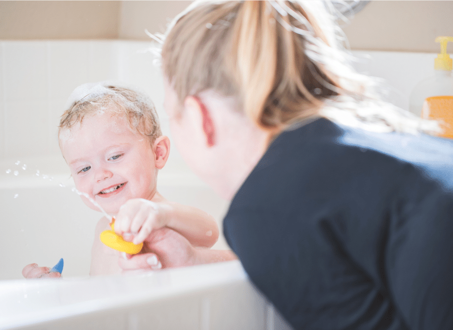 Splashing in the bath tub Water confidence starts before swimming lessons.
